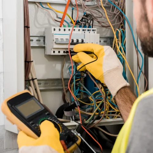 cropped-image-of-electrician-checking-electrical-b-2021-08-29-22-50-24-utc-scaled